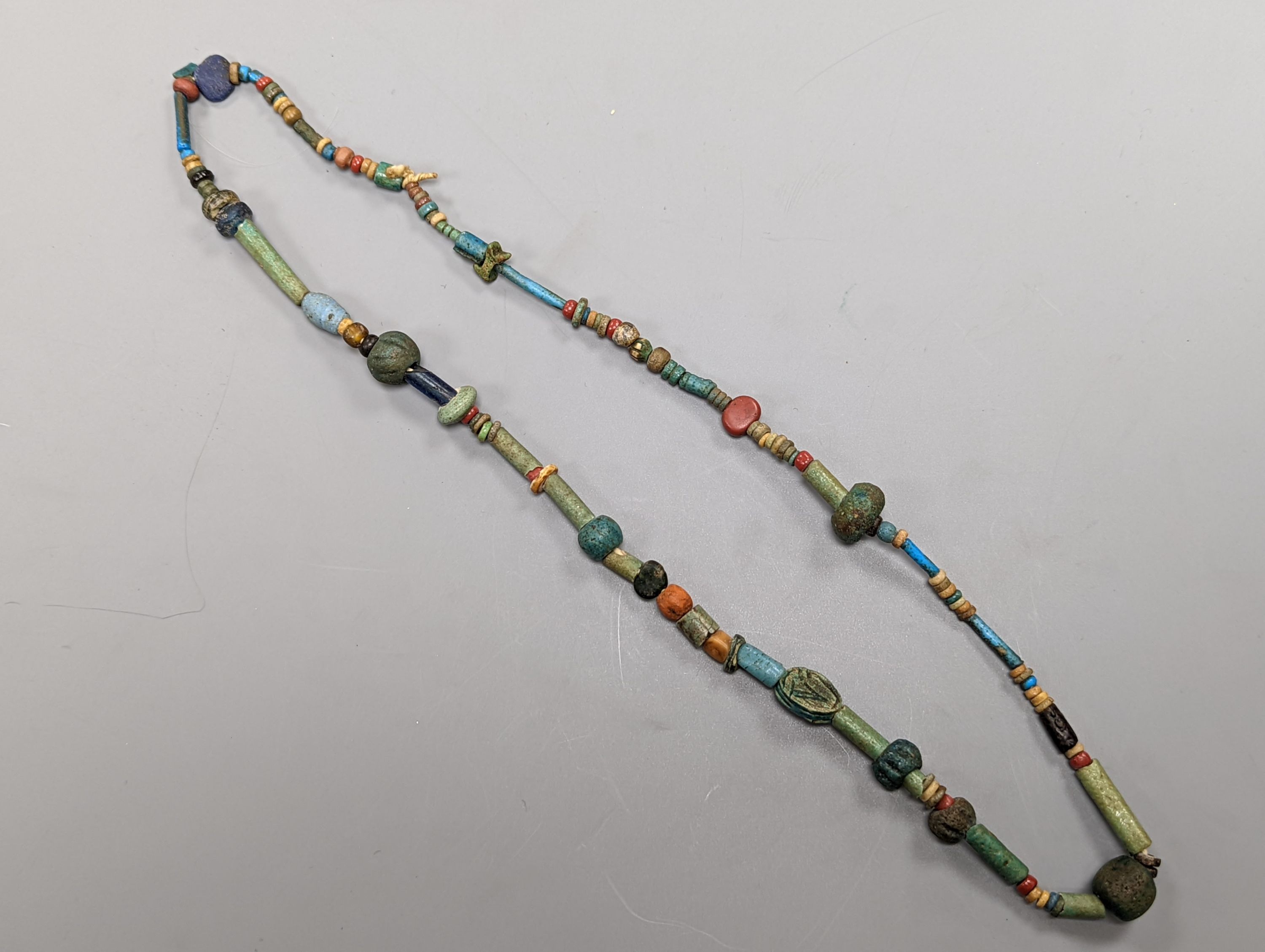 An ancient Egyptian faience and hardstone bead and scarab necklace and a small blue John bowl, 7cm